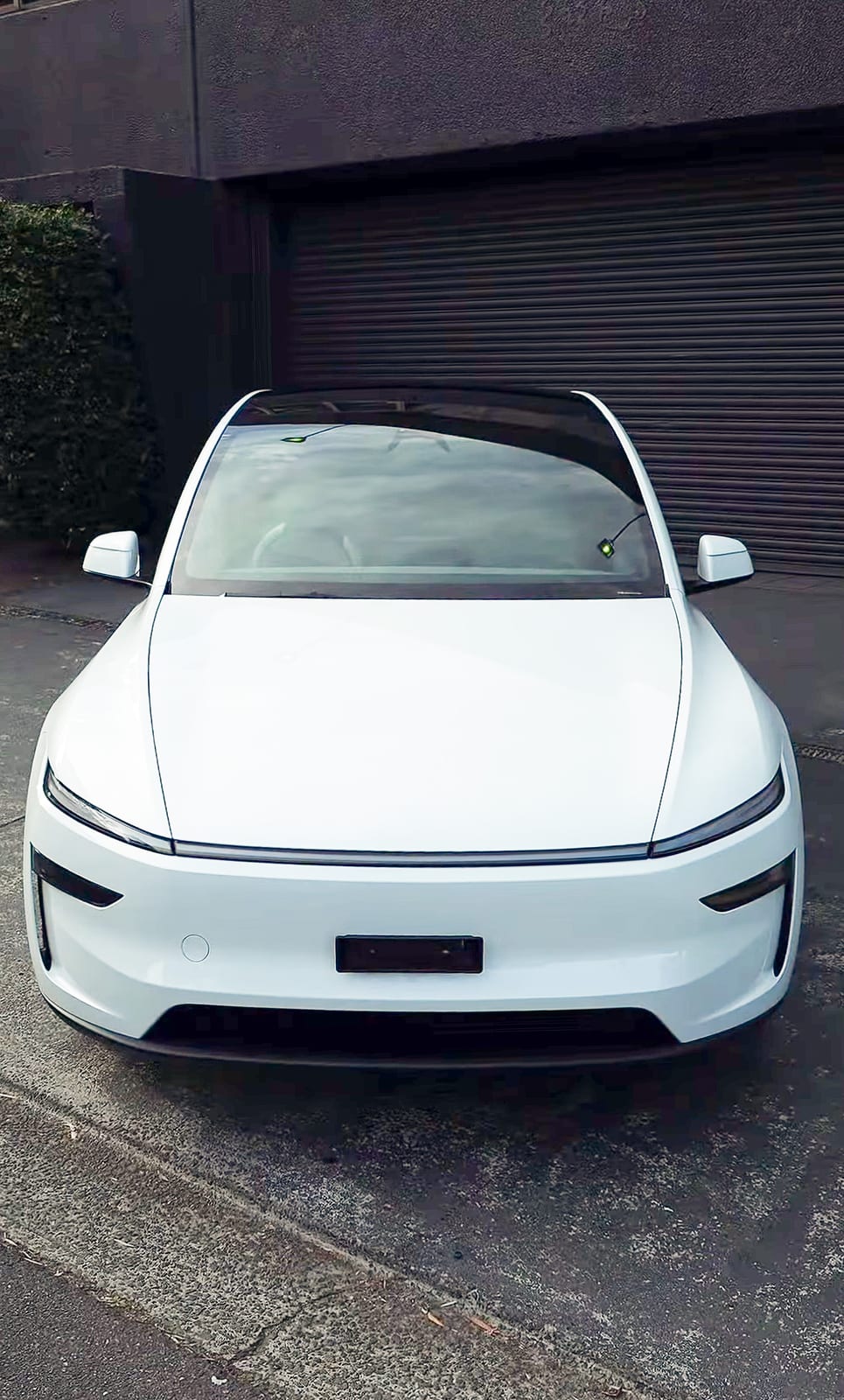 EV parked in a driveway, front view