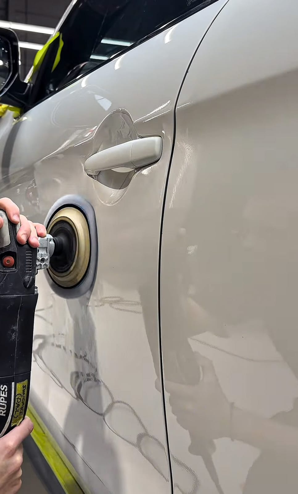 Machine polishing a door panel during paint correction